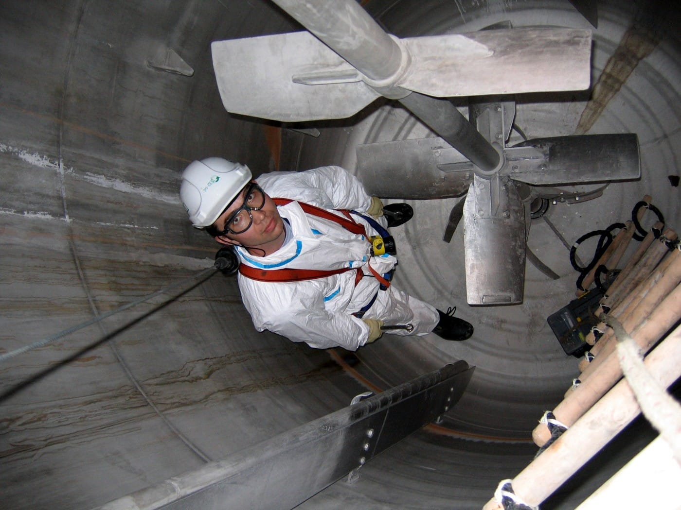 Stainless steel stirred tank reactor interior showing impeller blades shaft and baffles